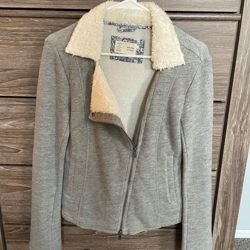 Grey zip up sweater.